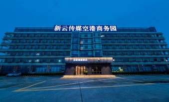 The front view at night showcases a prominent Chinese character sign atop the building at Home Inn (Shanghai Pudong Airport)