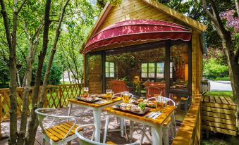 The hotel features a covered gazebo with a wooden deck, where guests can enjoy outdoor dining with a table and chairs at Grand Millennium Shanghai HongQiao