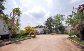 a residential area with houses surrounded by trees and bushes , located near a street at OYO 926 Sydney Resort