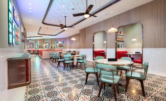 The restaurant features a central arrangement of tables and chairs, complemented by an open floor plan at Lisboeta Macau
