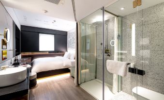 The room features a modern bathroom with a spacious shower and a centrally located bed, along with an additional room at CitiGO Hotel Sanyuanqiao Beijing