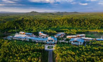 aerial view of a large resort surrounded by trees , with multiple buildings and restaurants visible at Pullman Changbaishan Resort