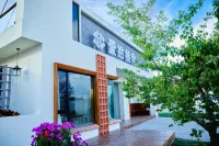 yishisanjianminsu Hoteles en Condado de Tekes