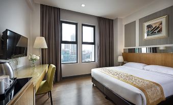 a spacious bedroom with large windows and a double bed in the center at Hotel Transit Kuala Lumpur