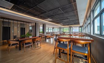 a large dining room with multiple tables and chairs arranged for a group of people to sit and eat at Mehood  Lestie Hotel