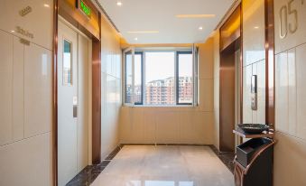 A spacious room in an apartment or building, serving as a residence, with windows and doors at Lavande Hotel (Beijing Changyang Metro Station)