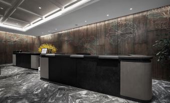 The lobby features a modern design with a wood-paneled wall behind it at Byland Star Hotel (Yiwu International Trade City)