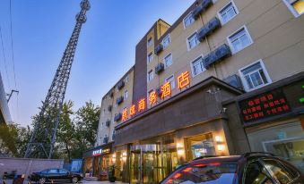 The hotel in an urban setting offers views of the front and side, with cars passing by at Jingcheng Business Hotel (Beijing Shilihe Metro Station)