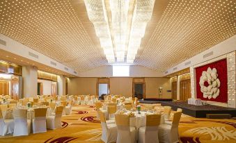 a large , well - decorated banquet hall with numerous tables and chairs set up for a formal event at Marino Beach Colombo