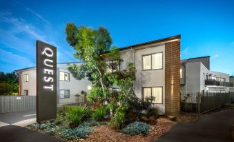 "a modern apartment building with a large sign reading "" quest "" in front of it , surrounded by greenery" at Quest Bendigo Central