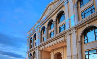 The front of a large building is intricately decorated and offers a beautiful view at night at Sofitel Macau at Sofitel Macau at Ponte 16