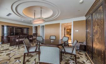 A spacious room with a central arrangement of chairs and a table, adjacent to an open living area at Boyue Hotel Shanghai Air China Hongqiao Airport