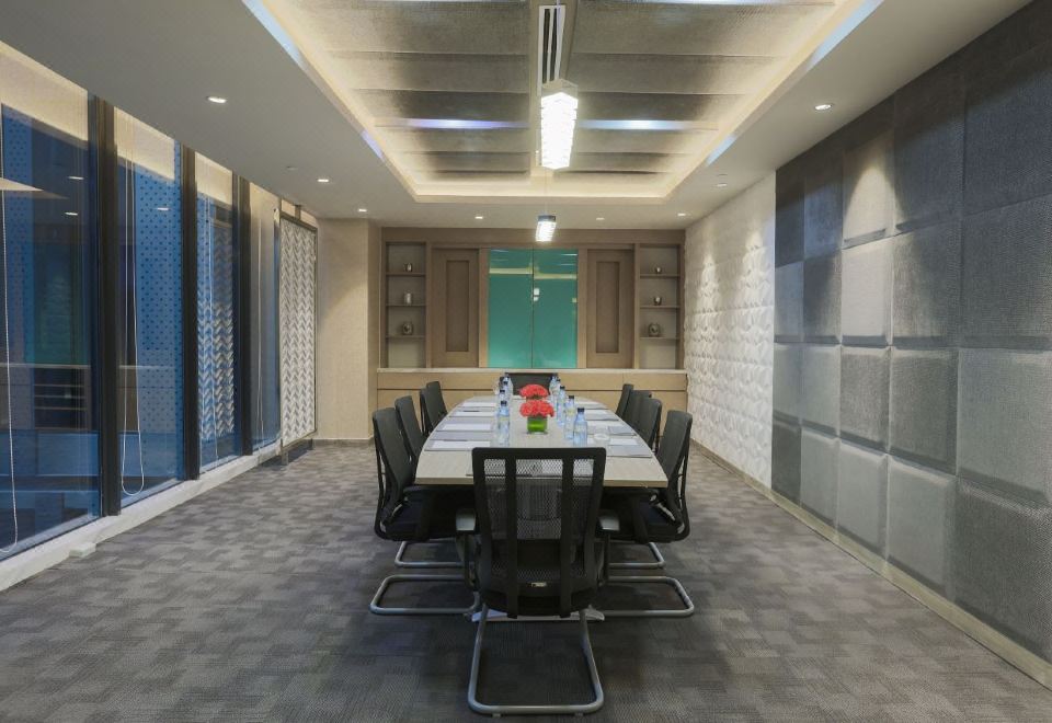 a conference room with a long table , chairs , and windows , creating a bright and spacious atmosphere at bai Hotel Cebu