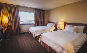 a hotel room with two beds , one on the left and one on the right side of the room at The Explorer Hotel