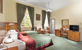 a hotel room with two beds , one on the left and one on the right side of the room at Green Garden Hotel