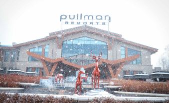 "a large building with a sign that says "" pullman resorts "" is surrounded by snow and trees" at Pullman Changbaishan Resort