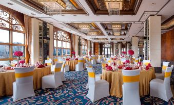 The ballroom is decorated with tables and chairs arranged for an event at Sofitel Macau at Sofitel Macau at Ponte 16