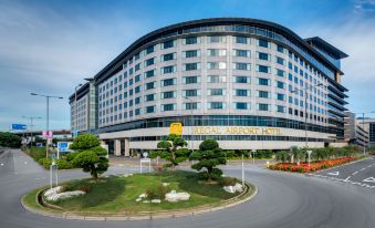 The front view of an office building in Hong Kong, seen from across a large parking lot at Regal Airport Hotel