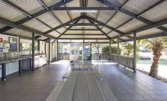 an open - air area with a wooden floor and metal beams , possibly for an indoor sports facility at Nrma Sydney Lakeside Holiday Park