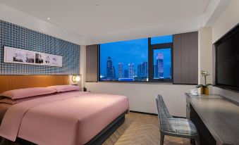 The bedroom features large windows and a bed in the center, with an ultra-modern design at Kaison Pusham Hotel