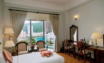 a hotel room with a large window overlooking a body of water , providing a scenic view at Seagull Hotel
