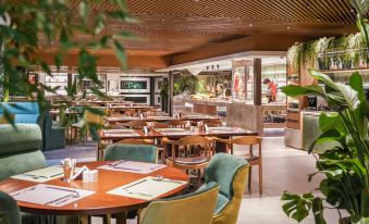 The restaurant has a dining room in the center with tables and chairs specifically designed for business luncheons at Pullman Shanghai Skyway Hotel