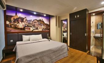 a hotel room with a large bed in the center of the room , surrounded by furniture and decorations at Eurotel Angeles