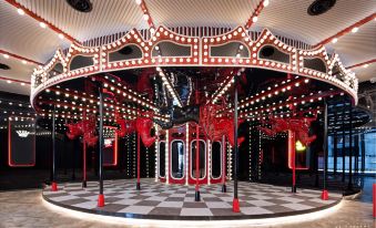 At night, there is a room with ceiling lights and an elaborate carousel in front at Radisson RED Hotel Zhuhai Gongbei Port