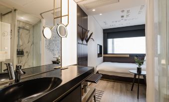 In the middle room, there is a modern bathroom with a sink, bed, and a large mirror at CitiGO Hotel Jing'an Shanghai