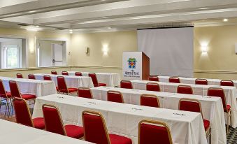 a conference room set up for a meeting , with chairs arranged in rows and a projector on the wall at Grand Palms Spa & Golf Resort