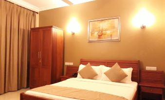 a neatly made bed with white sheets and two pillows is in a hotel room at Chelsea Hotel