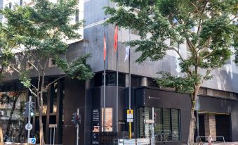 The store on 12th street has a large tree in front at Empire Hotel Hong Kong－Wan Chai