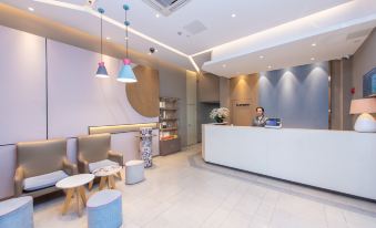 The lobby features a reception desk, an ATM, and various surrounding furniture at Pebble Hotel (Shanghai New International Expo Center Longyang Road Metro Station)