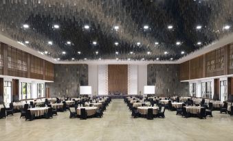 a large , empty banquet hall with multiple tables and chairs set up for a formal event at Jsi Resort