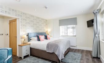 a bedroom with two beds , one on the left and one on the right side of the room at The Orange Tree Thornham