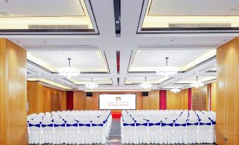 A spacious event room is arranged with rows of chairs facing the front at Fuzhou Le'an New Century Mingting Hotel