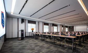 a spacious conference room with rows of long tables at Hampton by Hilton