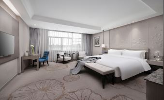A spacious and elegantly furnished room with a bed, desk, and chair in the center at Byland Star Hotel (Yiwu International Trade City)