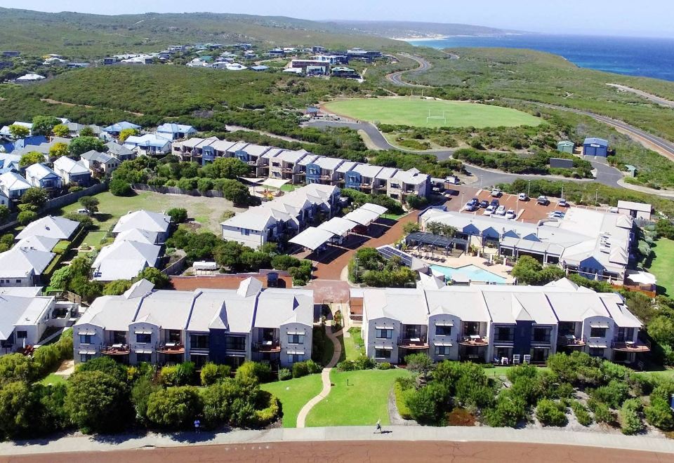 aerial view of a residential area with multiple houses and a golf course in the background at Margarets Beach Resort