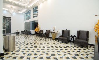 a modern , white - walled room with black and gold patterned flooring , featuring comfortable seating arrangements and elegant décor at SureStay Hotel by Best Western Vientiane