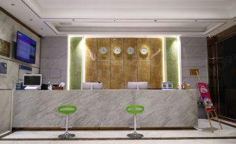 The lobby is equipped with wall clocks and an ATM machine for employee use at Green Nest Hotel (Guangzhou Yongtai Metro Station)