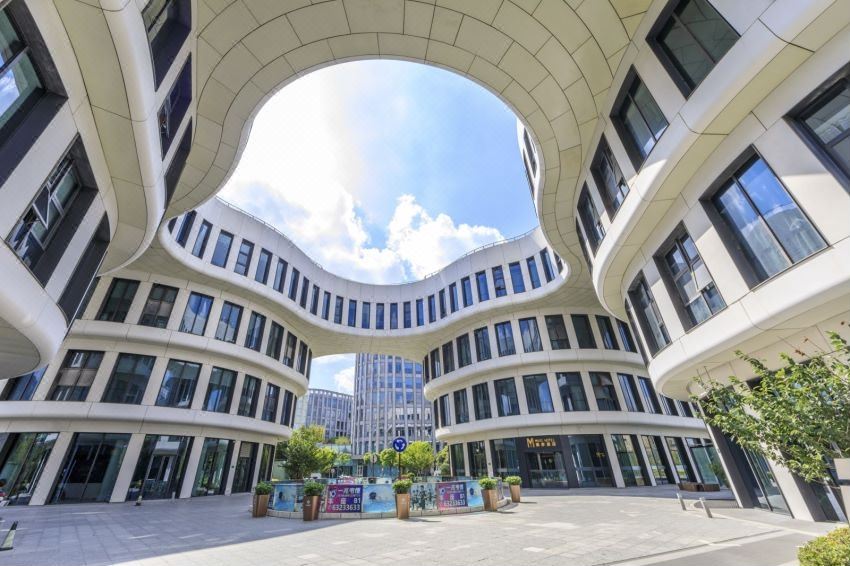 The courtyard and entrance of a modern urban building with contemporary architecture at MUYI Hotel Hongqiao Hub Shanghai