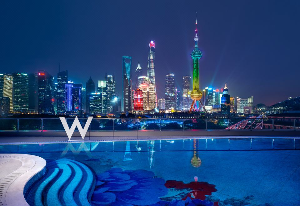 At night, the pool offers a stunning view of the city skyline and illuminated skyscrapers at W Shanghai - The Bund