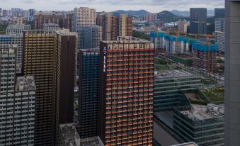 The city skyline features tall buildings and skyscrapers against a backdrop of a clear blue sky at Atour Hotel (Shenzhen Nanshan Vanke Yuncheng)