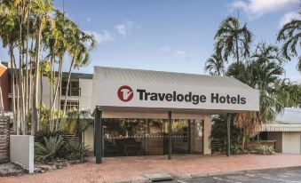 the exterior of a travelodge hotel , with its entrance and parking lot visible in the background at The Leea Resort Darwin