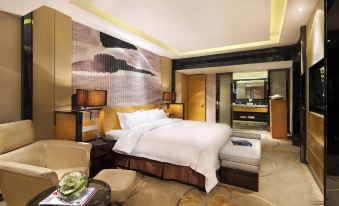 The middle room features a spacious bed with a sitting area and a table on each side at Tianyuan Hotel
