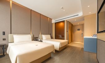 The main bedroom area features a modern design with double beds and a large flat-screen television at Guangzhou Atour Hotel(Zhujiang New Town Wuyangcun Subway Station)