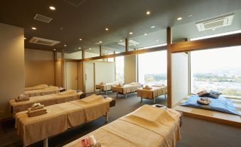 a modern , well - lit room with multiple beds and skylights , giving the impression of an esthetician 's office at Hotel Clad