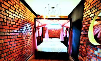 a bedroom with brick walls and a white canopy bed , giving it a cozy and romantic atmosphere at Petak Padin Cottage by The Pool