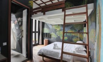 a modern bedroom with a wooden bed and a ladder leading to an upstairs area at The Happy 8 Retreat @ Kuala Sepetang